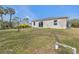 Spacious backyard with grassy area and partial view of home at 5389 Ocarina Rd, North Port, FL 34291