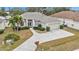 Single-Gathering home with a large driveway and landscaped yard at 5608 New Covington Dr, Sarasota, FL 34233