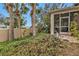 Landscaped backyard with tropical plants and a screened porch at 5608 New Covington Dr, Sarasota, FL 34233