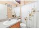 Clean bathroom with floral shower curtain, single sink vanity, and toilet at 5608 New Covington Dr, Sarasota, FL 34233