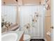 Clean bathroom with floral shower curtain, single sink vanity, and toilet at 5608 New Covington Dr, Sarasota, FL 34233