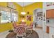 Cozy breakfast nook with yellow walls and a round glass-top table at 5608 New Covington Dr, Sarasota, FL 34233