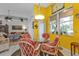 Bright breakfast nook with yellow walls and a round glass-top table at 5608 New Covington Dr, Sarasota, FL 34233