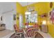 Bright breakfast nook with yellow walls and a round glass-top table at 5608 New Covington Dr, Sarasota, FL 34233