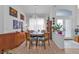 Bright dining room with round table and four chairs, hardwood floors, and large windows at 5608 New Covington Dr, Sarasota, FL 34233