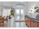 Bright and spacious entryway with double doors and wood cabinet at 5608 New Covington Dr, Sarasota, FL 34233