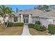 Single-story house with double doors and landscaped yard at 5608 New Covington Dr, Sarasota, FL 34233