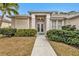 Attractive home exterior featuring double doors and lush landscaping at 5608 New Covington Dr, Sarasota, FL 34233