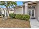 House exterior with double doors and well-manicured landscaping at 5608 New Covington Dr, Sarasota, FL 34233