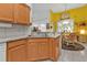 Kitchen features wood cabinets and a breakfast nook at 5608 New Covington Dr, Sarasota, FL 34233