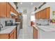 Kitchen with light wood cabinets, granite countertops, and stainless steel appliances at 5608 New Covington Dr, Sarasota, FL 34233