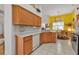 Kitchen with light wood cabinets, granite countertops, and stainless steel appliances at 5608 New Covington Dr, Sarasota, FL 34233