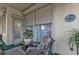 Serene screened porch with wicker chairs and potted plants at 5608 New Covington Dr, Sarasota, FL 34233