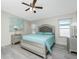 Main bedroom with silver upholstered bed and ocean decor at 562 Portside Dr, North Port, FL 34287