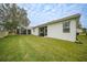Landscaped backyard with screened patio and grassy area at 6049 Grand Cypress Blvd, North Port, FL 34287