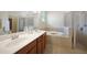 Bathroom with double vanity, soaking tub, and shower at 6049 Grand Cypress Blvd, North Port, FL 34287