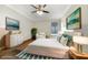 Virtually staged bedroom with wood floors and large bed at 6049 Grand Cypress Blvd, North Port, FL 34287