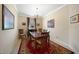 Elegant dining room with wood table and red carpet at 6049 Grand Cypress Blvd, North Port, FL 34287