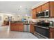 Kitchen with stainless steel appliances and wood cabinets at 6049 Grand Cypress Blvd, North Port, FL 34287