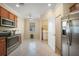 Kitchen with stainless steel appliances and laundry area at 6049 Grand Cypress Blvd, North Port, FL 34287