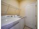 Laundry room with washer, dryer and overhead shelving at 6049 Grand Cypress Blvd, North Port, FL 34287