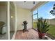 Screened patio with grill and lush landscaping at 6049 Grand Cypress Blvd, North Port, FL 34287