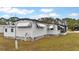 Well-maintained mobile home with awning and yard at 6305 Parkview Ct, North Port, FL 34287
