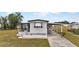 Front view of a white mobile home with carport at 6305 Parkview Ct, North Port, FL 34287