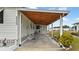 Side view of a mobile home with carport and bicycle at 6305 Parkview Ct, North Port, FL 34287