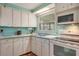 Bright kitchen with white cabinets and light blue walls at 6305 Parkview Ct, North Port, FL 34287