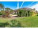 Landscaped backyard with screened enclosure and lush greenery at 632 Balsam Apple Dr, Venice, FL 34293