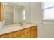 Updated bathroom with wood cabinets, large mirror, and walk-in shower at 632 Balsam Apple Dr, Venice, FL 34293