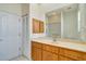 Bathroom features a vanity with wood cabinets and a large mirror at 632 Balsam Apple Dr, Venice, FL 34293