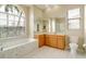 Bathroom features a large vanity, soaking tub, and separate shower at 632 Balsam Apple Dr, Venice, FL 34293
