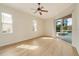 Bright bedroom with pool view, ceiling fan, and sliding glass doors at 632 Balsam Apple Dr, Venice, FL 34293