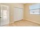 Spacious bedroom with light walls, wood flooring, and white closet doors at 632 Balsam Apple Dr, Venice, FL 34293