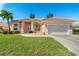 Pink one-story home with a two-car garage and landscaped lawn at 632 Balsam Apple Dr, Venice, FL 34293