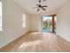 Living area with wood-look floors and sliding glass doors to the pool at 632 Balsam Apple Dr, Venice, FL 34293