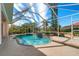 Large screened-in pool with a fountain and surrounding landscaping at 632 Balsam Apple Dr, Venice, FL 34293