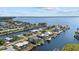 Aerial view showcasing waterfront property with canal access and nearby homes at 258 Beeney Se Rd, Port Charlotte, FL 33952