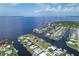 Aerial view of waterfront home on a canal with neighboring houses at 258 Beeney Se Rd, Port Charlotte, FL 33952