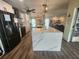 Modern kitchen with large island, white cabinets, and stainless steel appliances at 258 Beeney Se Rd, Port Charlotte, FL 33952