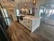 Modern kitchen featuring a large island, stainless steel sink, and white cabinets at 258 Beeney Se Rd, Port Charlotte, FL 33952