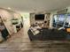Spacious living area featuring a large sectional sofa and stone accent wall at 258 Beeney Se Rd, Port Charlotte, FL 33952