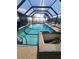 Relaxing screened-in pool and spa area with water views at 258 Beeney Se Rd, Port Charlotte, FL 33952