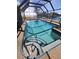 Inviting screened-in pool with a spa and water access views at 258 Beeney Se Rd, Port Charlotte, FL 33952