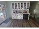 Modern wet bar with white cabinets, quartz countertop, and wine cooler at 258 Beeney Se Rd, Port Charlotte, FL 33952