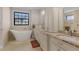 Elegant bathroom with double vanity, soaking tub, and walk-in shower at 1002 Messina Dr, Punta Gorda, FL 33950