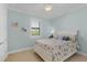 Light and airy bedroom with white bed and seashell bedding at 1002 Messina Dr, Punta Gorda, FL 33950