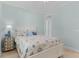 Bedroom with white bed, light blue walls, and seashell bedding at 1002 Messina Dr, Punta Gorda, FL 33950